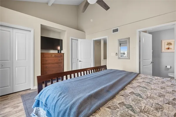 a bedroom with a bed and a flat tv screen