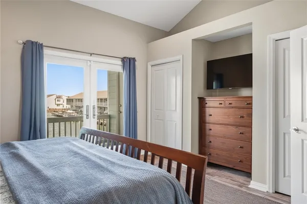 a bedroom with a bed and a flat tv screen
