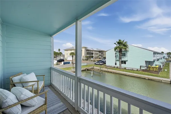 a view of a chairs and table in a balcony