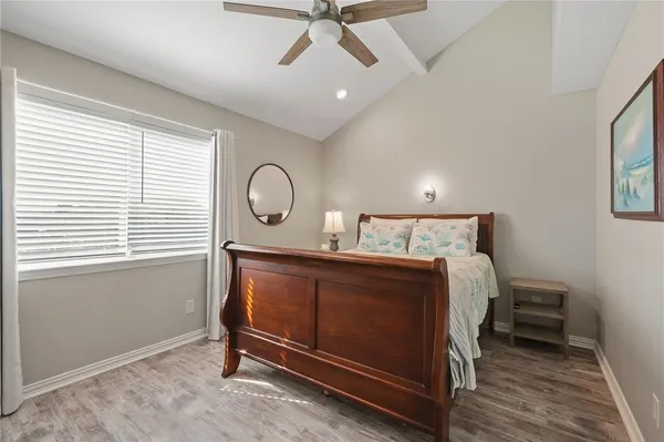 a bedroom with a large bed and a flat screen tv