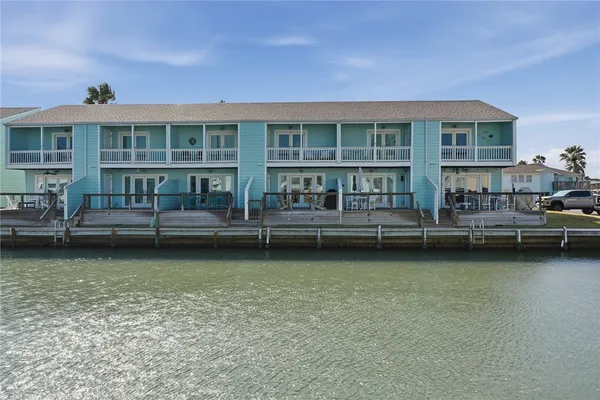 a front view of a house with outdoor seating and stairs