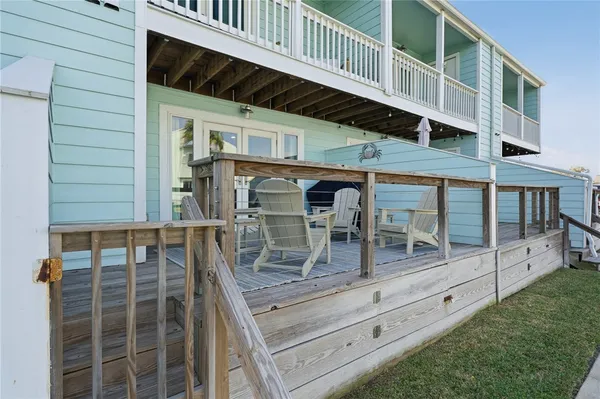 a view of house with roof deck and seating space