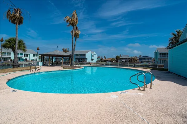 a swimming pool with outdoor seating and yard