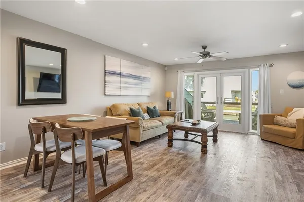 a living room with furniture and wooden floor