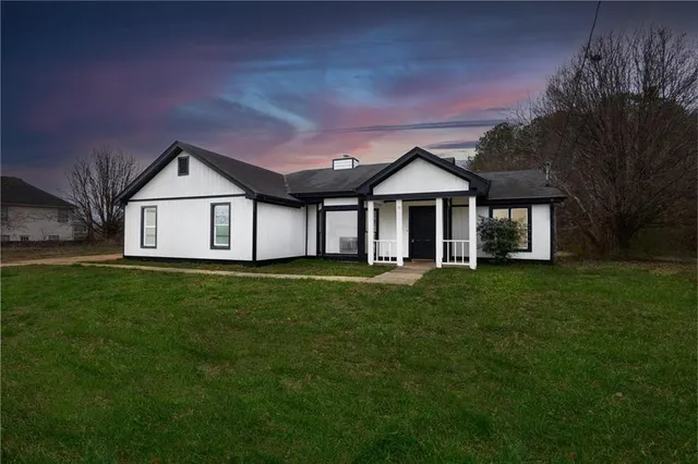 a front view of a house with a garden