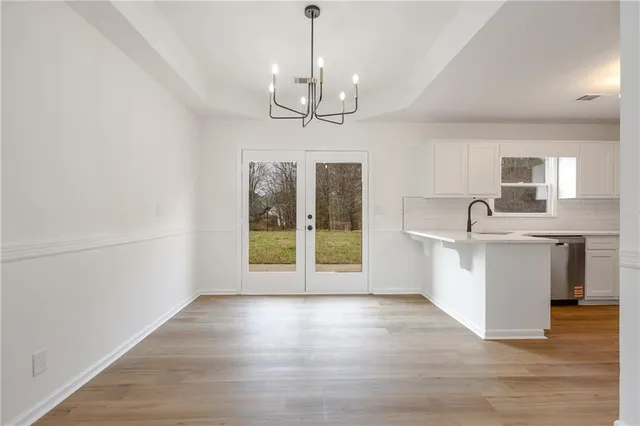 a view of kitchen with granite countertop cabinets and wooden floor