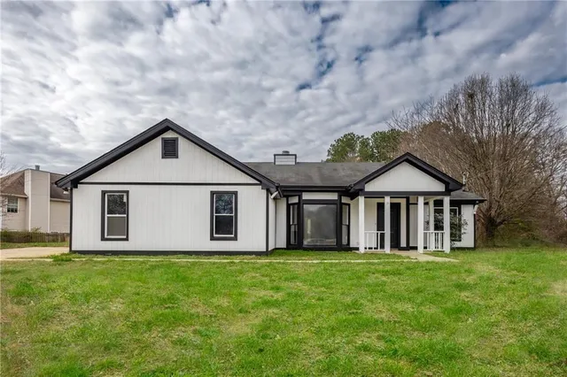 a front view of a house with yard and green space