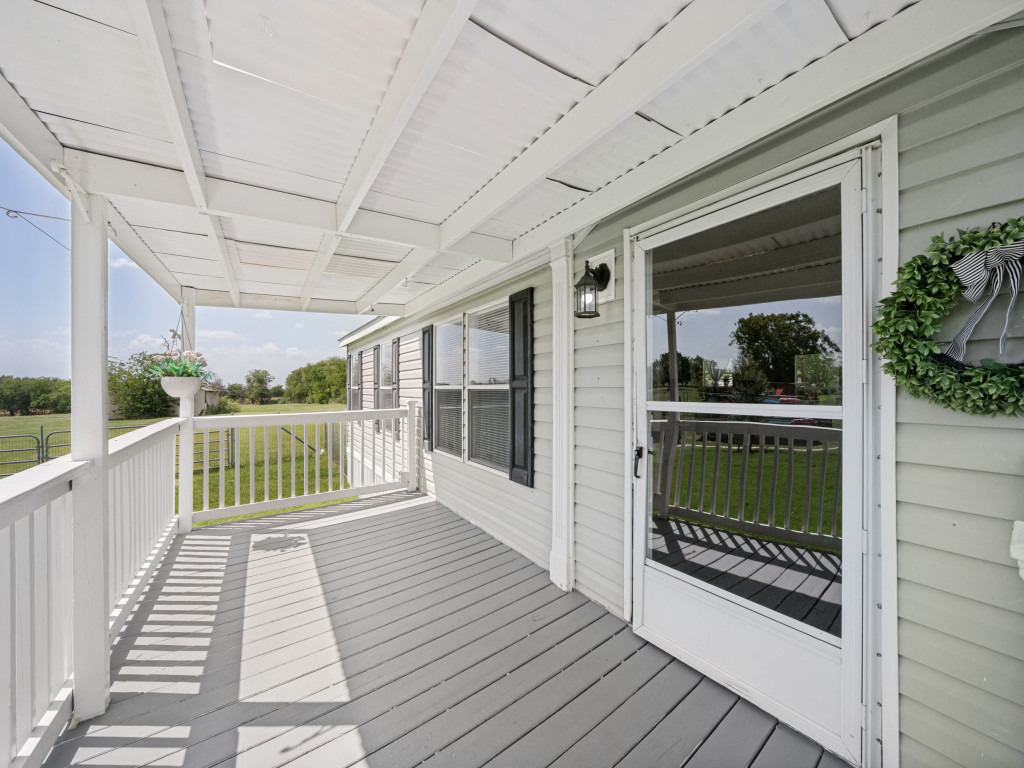 4654 Old Howard Road Temple, TX 76504 - Photo 3 of 25 Relax on this spacious covered porch, offering serene views of the surrounding green landscape.