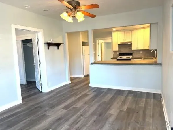a view of kitchen with wooden floor electronic appliances and window