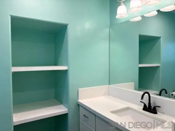 a bathroom with a sink and a mirror