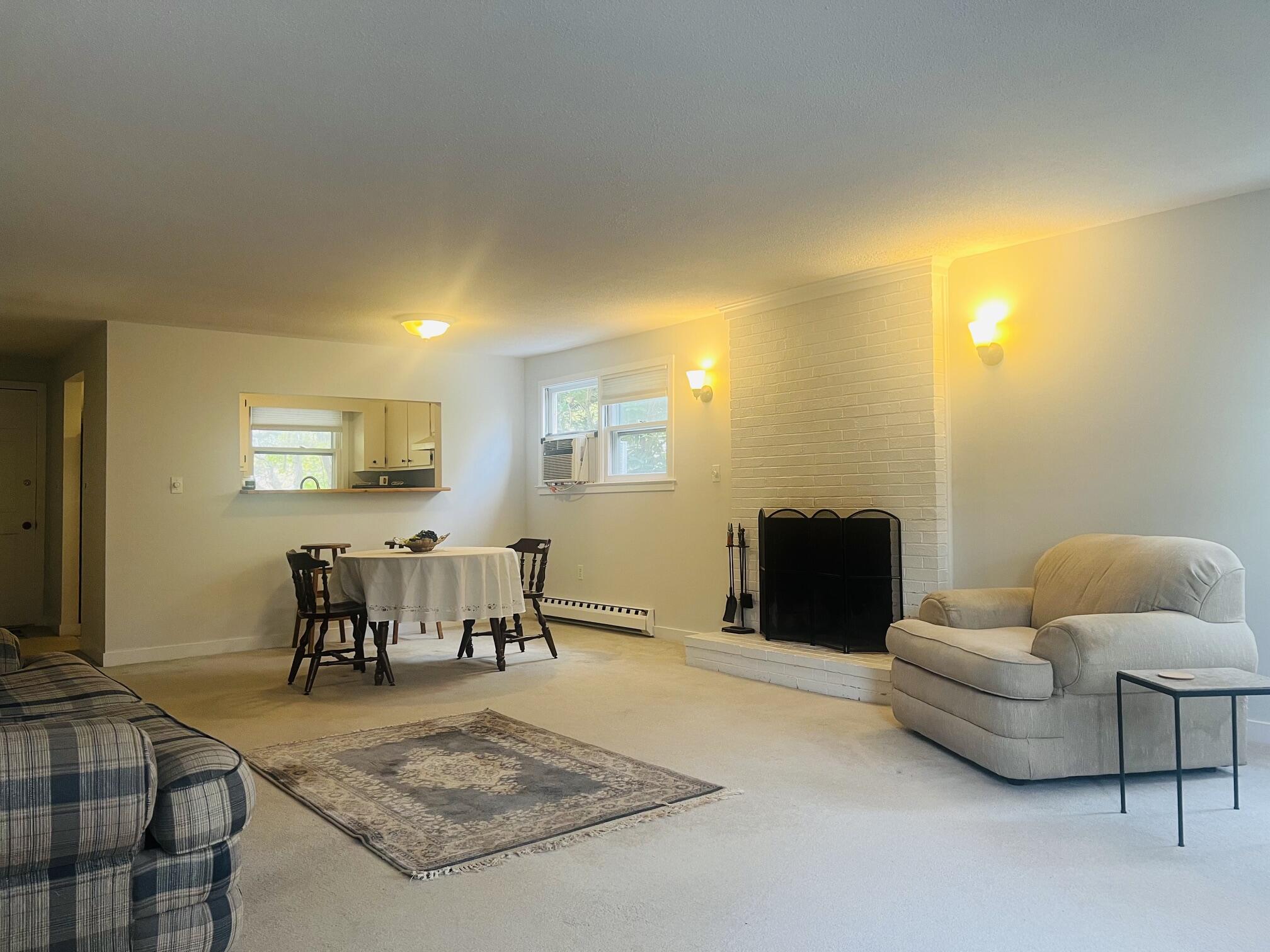 1431 Iyannough Road, Unit 1 Centerville, MA 02632 - Photo 5 of 28 a living room with furniture and a table