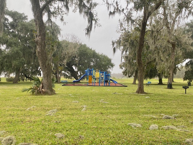 218 Cattle Drive Trail Angleton, TX 77515 - Photo 32 of 34 a view of a playground with basketball court