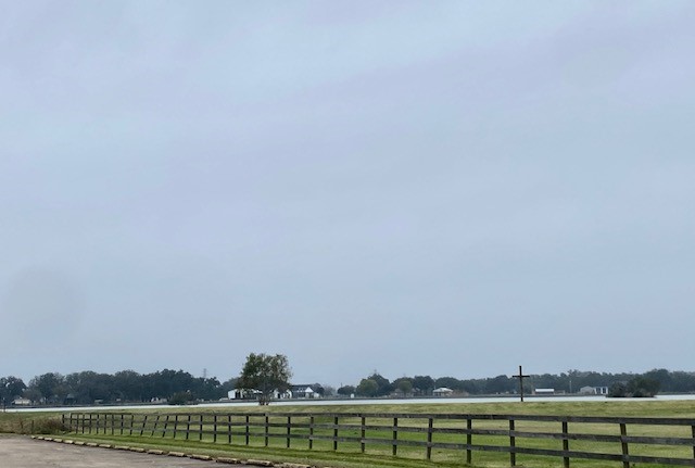 218 Cattle Drive Trail Angleton, TX 77515 - Photo 9 of 34 a view of a lake with houses in the background