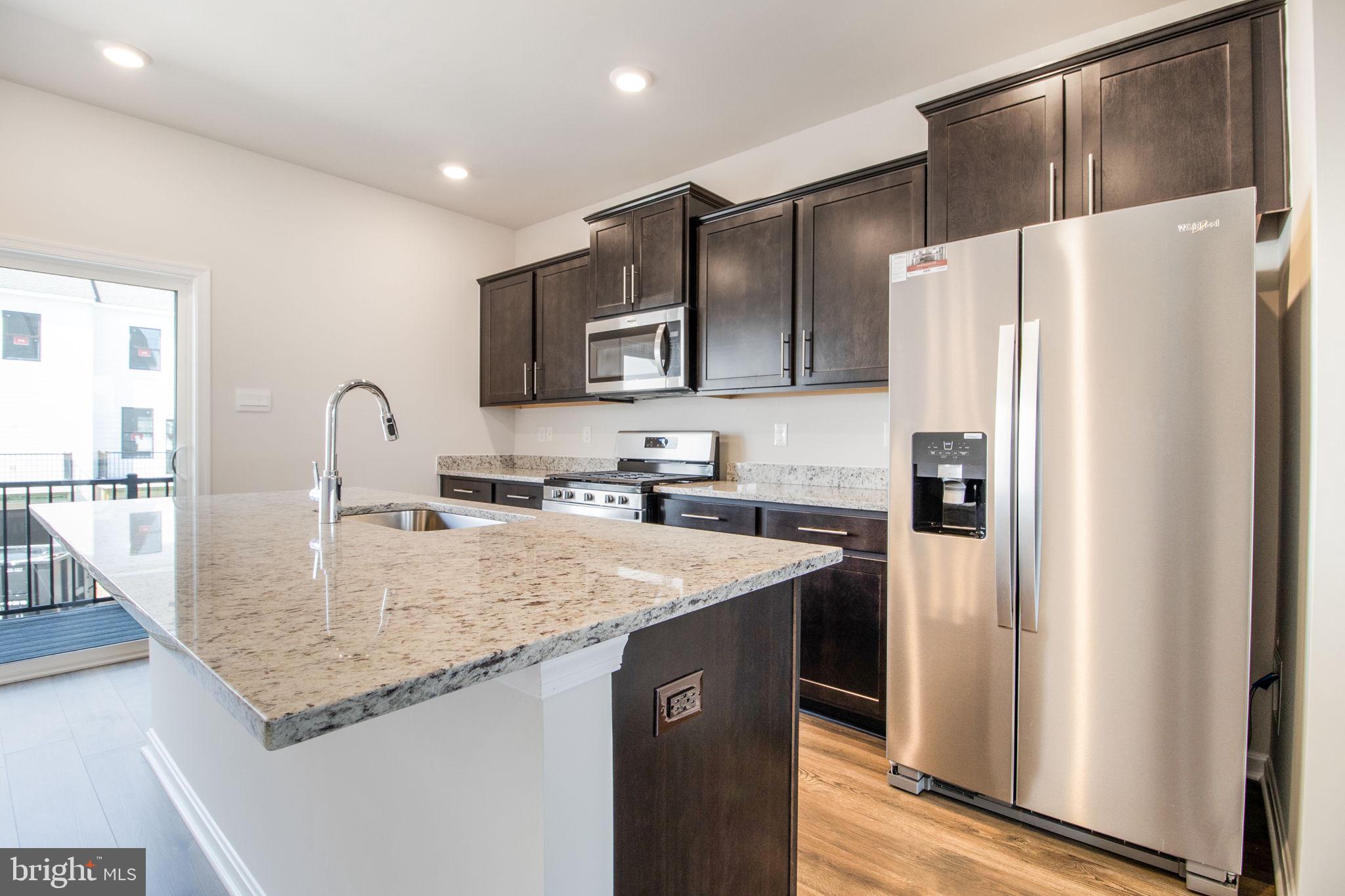 280 Ensemble Way Frederick, MD 21701 - Photo 2 of 25 a kitchen with stainless steel appliances granite countertop a refrigerator a sink and a stove