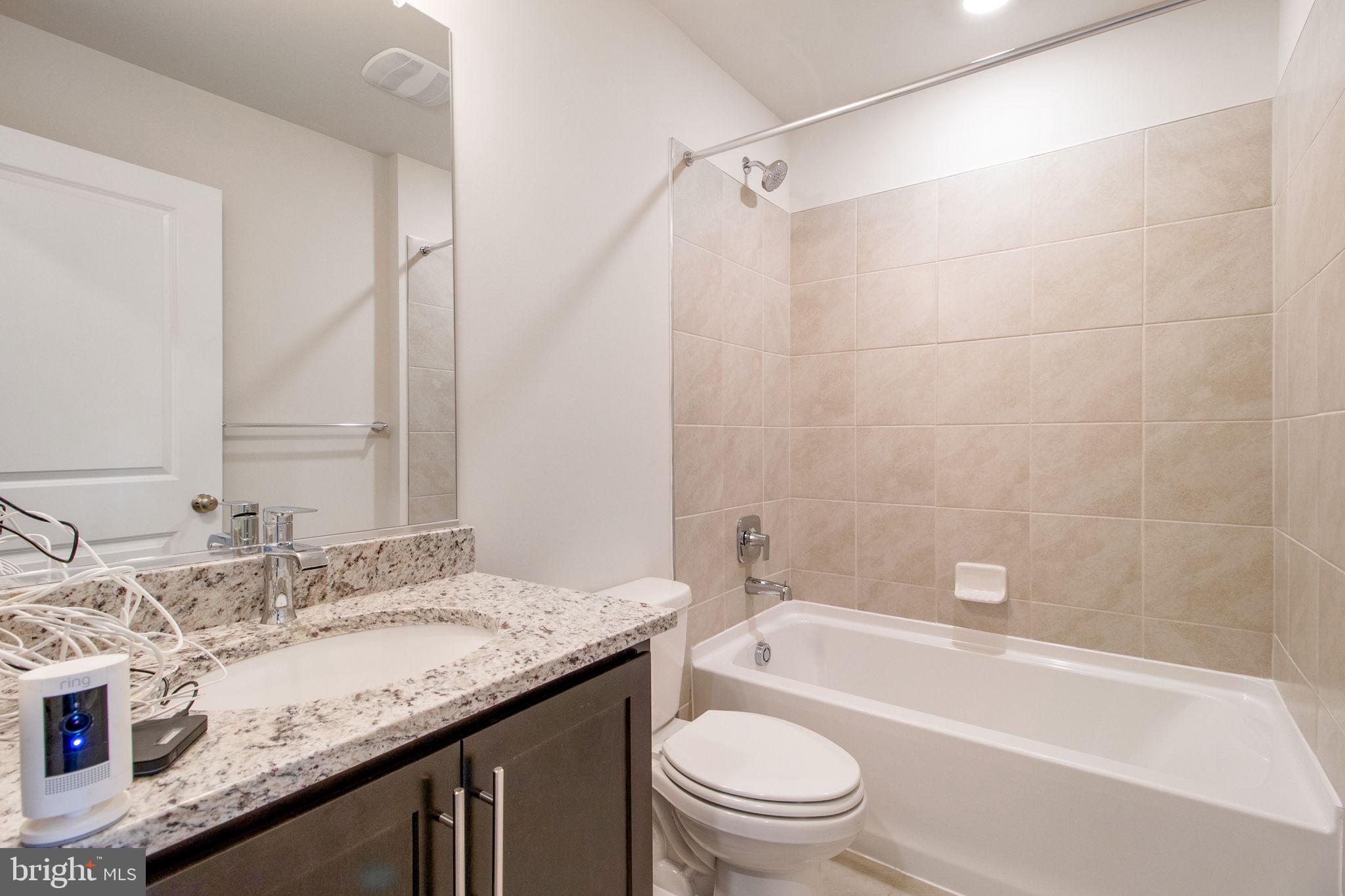 280 Ensemble Way Frederick, MD 21701 - Photo 24 of 25 a bathroom with a granite countertop sink a toilet and bathtub
