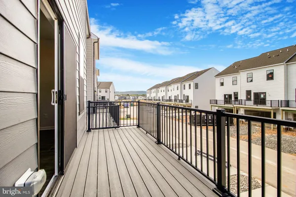 a view of a balcony with wooden floor and fence