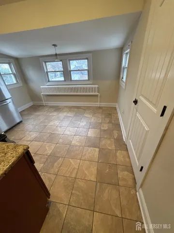a view of a livingroom with an empty space and window