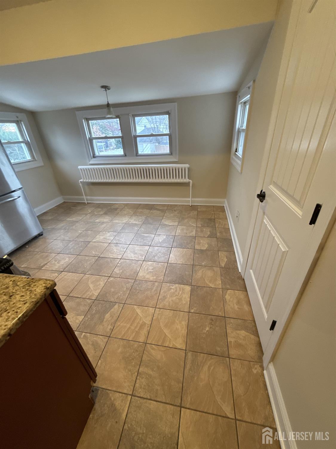 472 Cliff Road, Unit 3 Sewaren, NJ 07077 - Photo 8 of 16 a view of a livingroom with an empty space and window