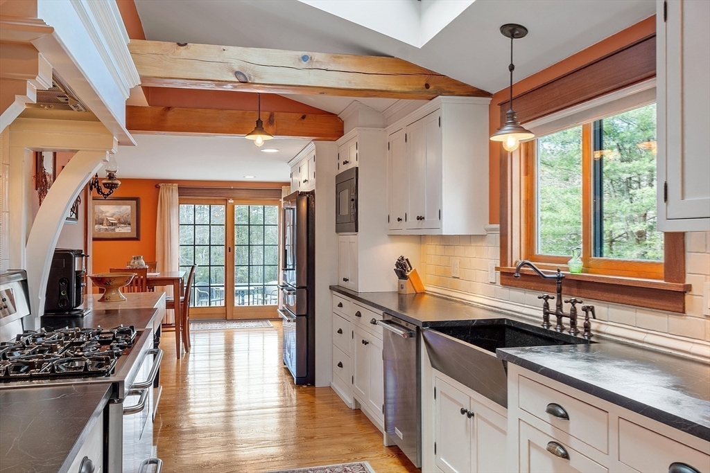 360 Teel Road Winchendon, MA 01475 - Photo 11 of 42 a kitchen with stainless steel appliances a sink a stove and a wooden floor