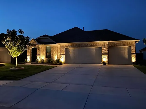 a front view of a house with yard and garage