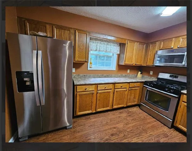 a room with a sink cabinets and wooden floor