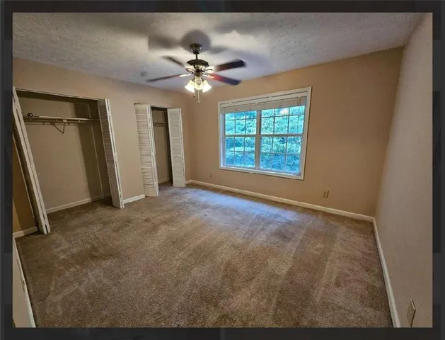a kitchen with granite countertop a sink and cabinets