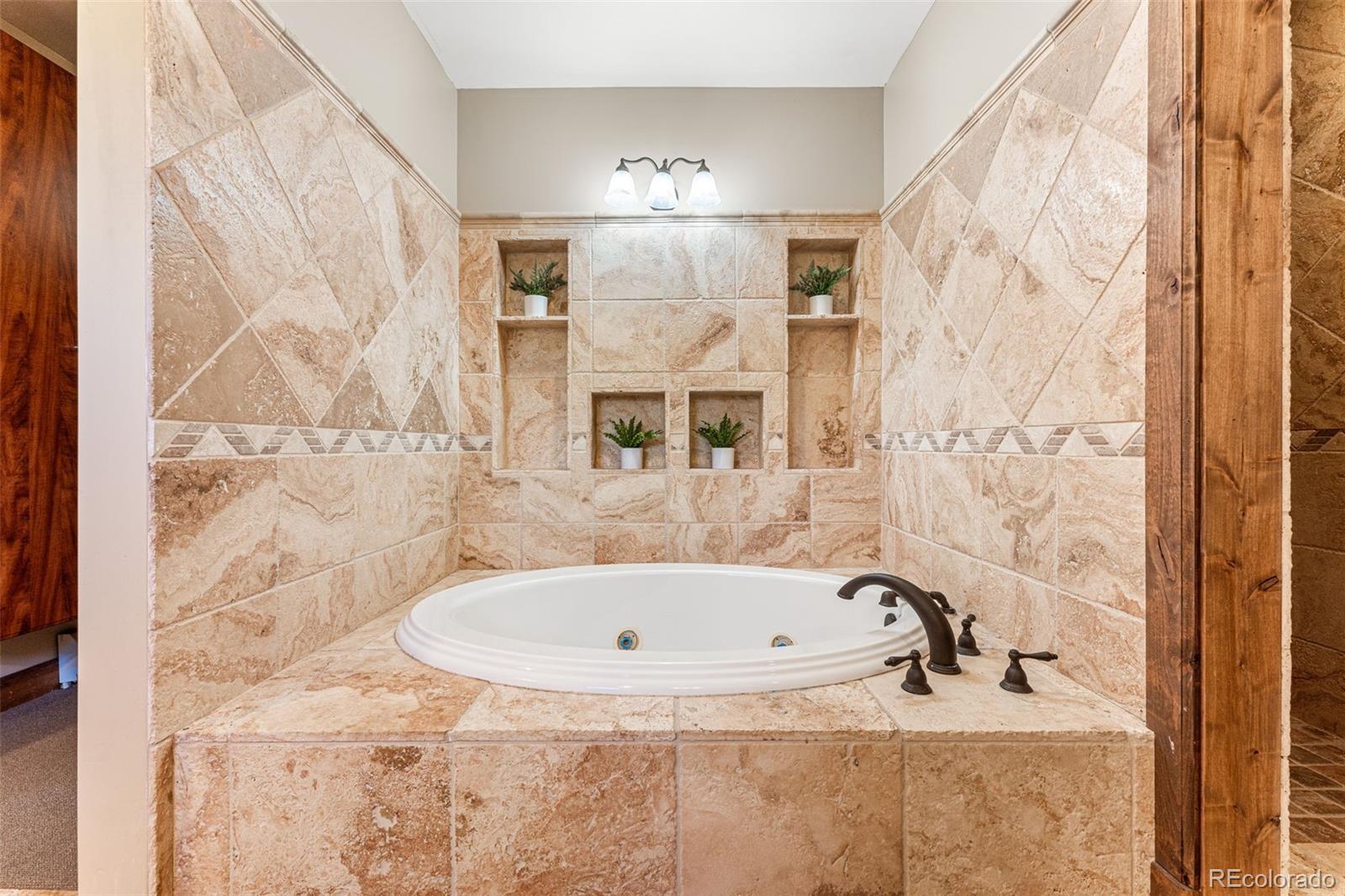 5970 Crestbrook Drive Morrison, CO 80465 - Photo 16 of 34 a bathroom with a bathtub and shower