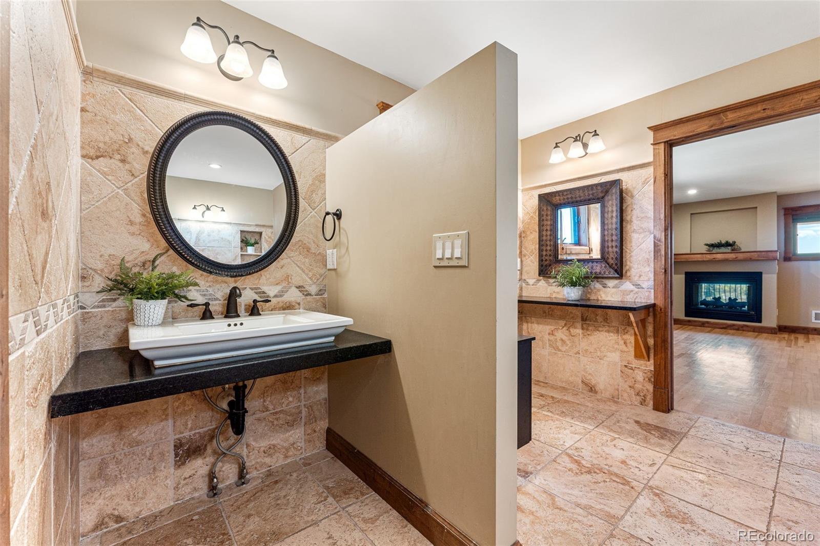 5970 Crestbrook Drive Morrison, CO 80465 - Photo 17 of 34 a bathroom with a sink and a mirror