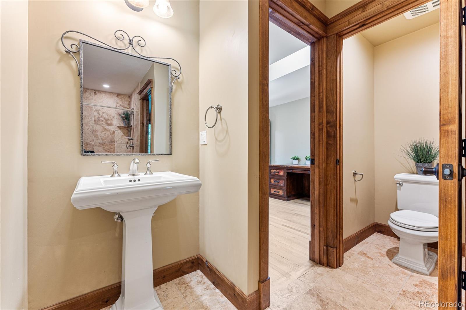 5970 Crestbrook Drive Morrison, CO 80465 - Photo 20 of 34 a bathroom with a sink a toilet and shower