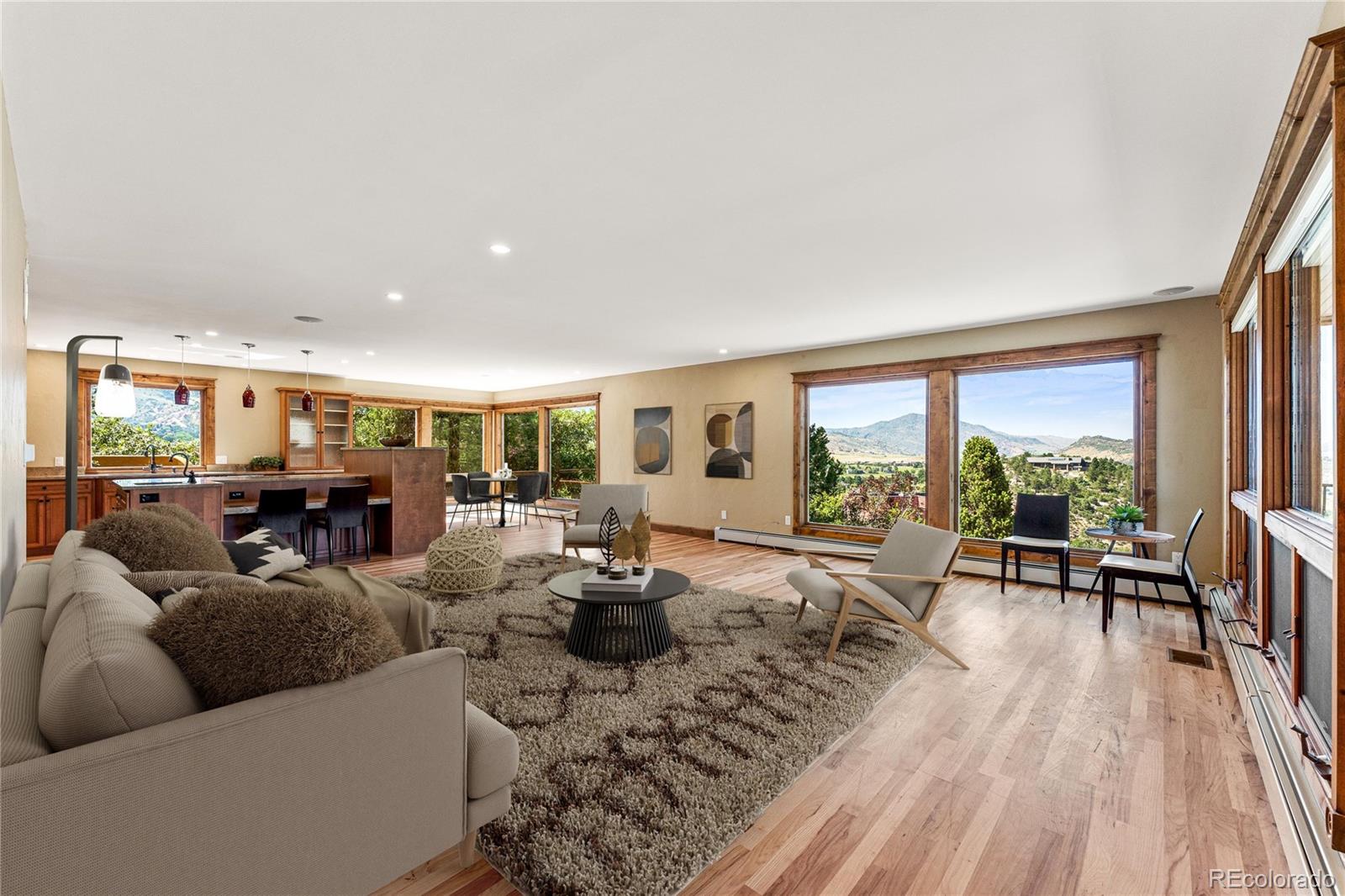 5970 Crestbrook Drive Morrison, CO 80465 - Photo 2 of 34 a living room with furniture fireplace and large windows