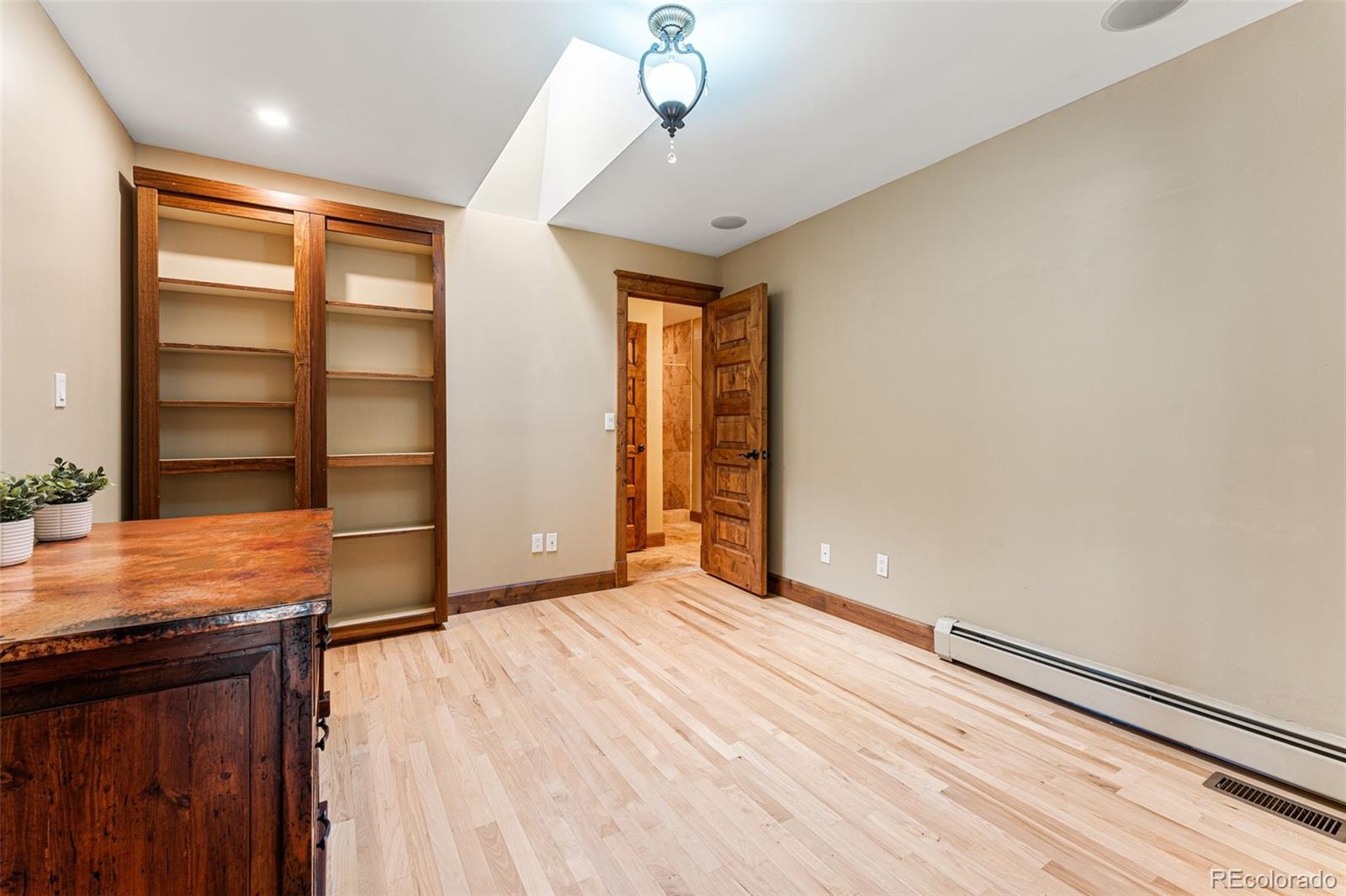 5970 Crestbrook Drive Morrison, CO 80465 - Photo 21 of 34 a view of empty room with wooden floor and fan