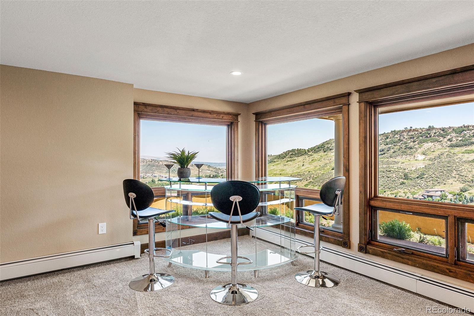 5970 Crestbrook Drive Morrison, CO 80465 - Photo 23 of 34 a living room with furniture and floor to ceiling windows