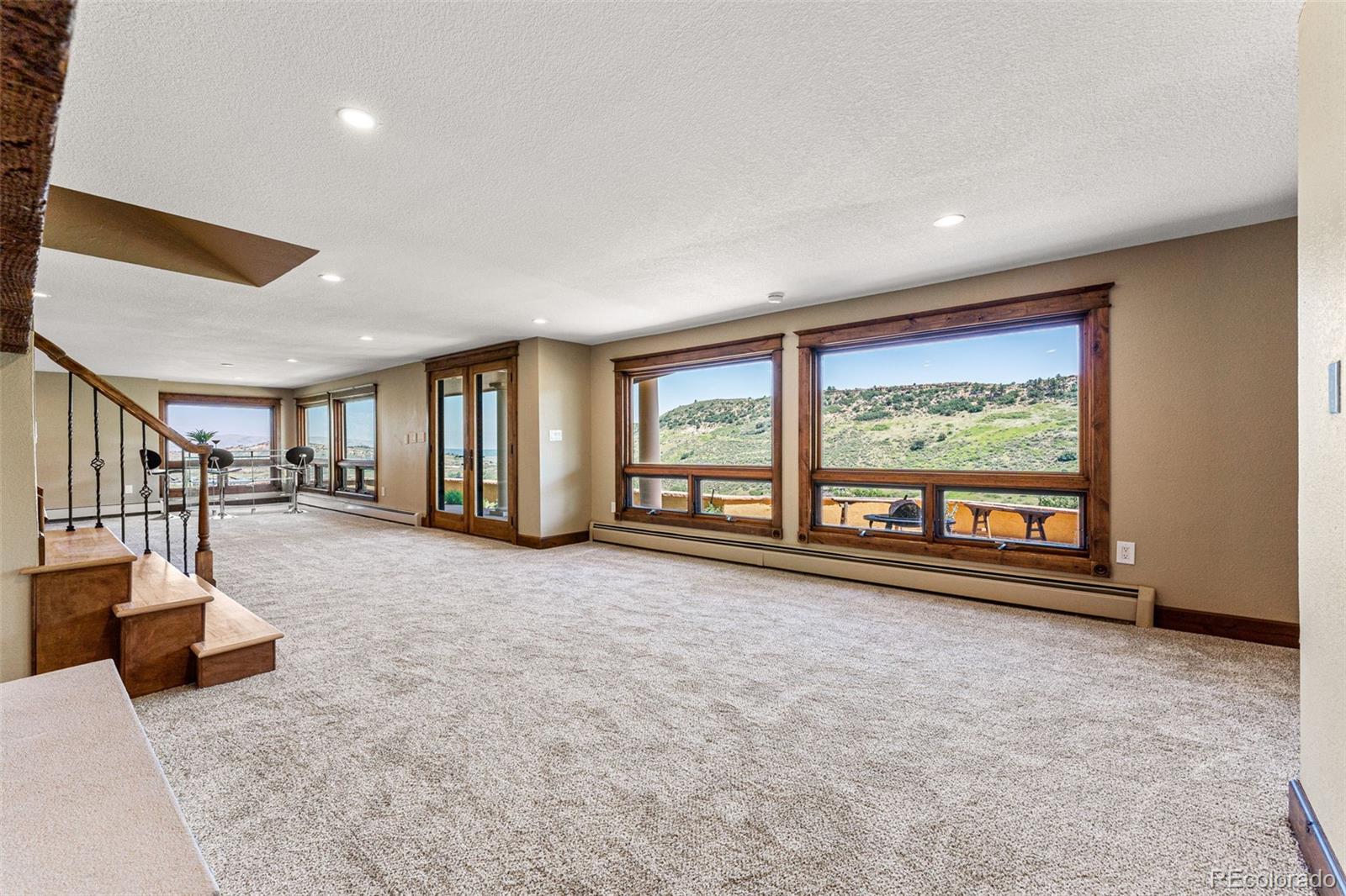 5970 Crestbrook Drive Morrison, CO 80465 - Photo 25 of 34 a living room with furniture and a large window