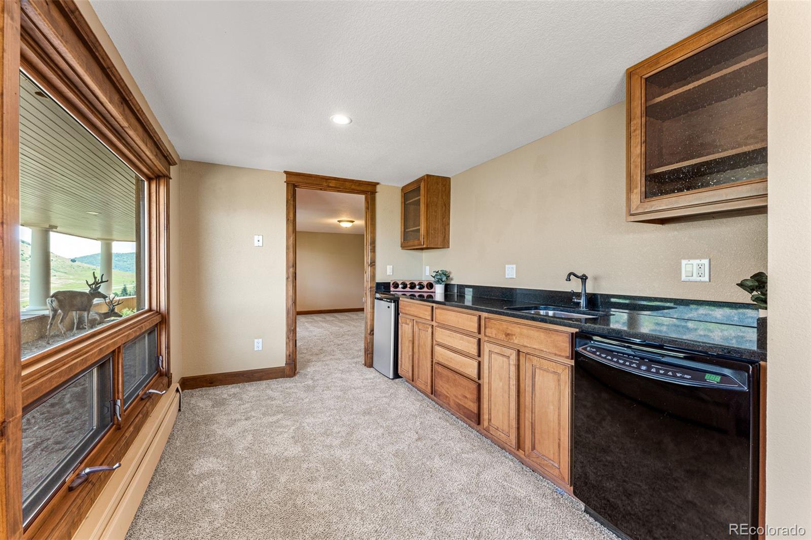 5970 Crestbrook Drive Morrison, CO 80465 - Photo 26 of 34 a large kitchen with granite countertop a stove and a sink