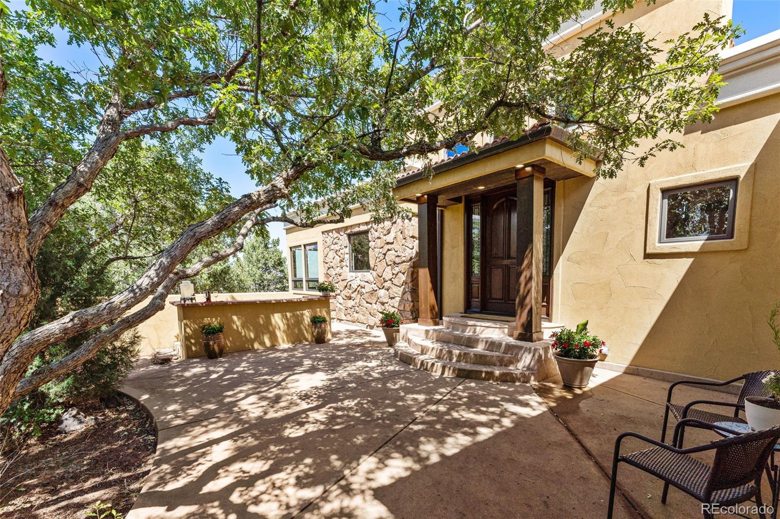5970 Crestbrook Drive Morrison, CO 80465 - Photo 7 of 34 a front view of a house with a yard