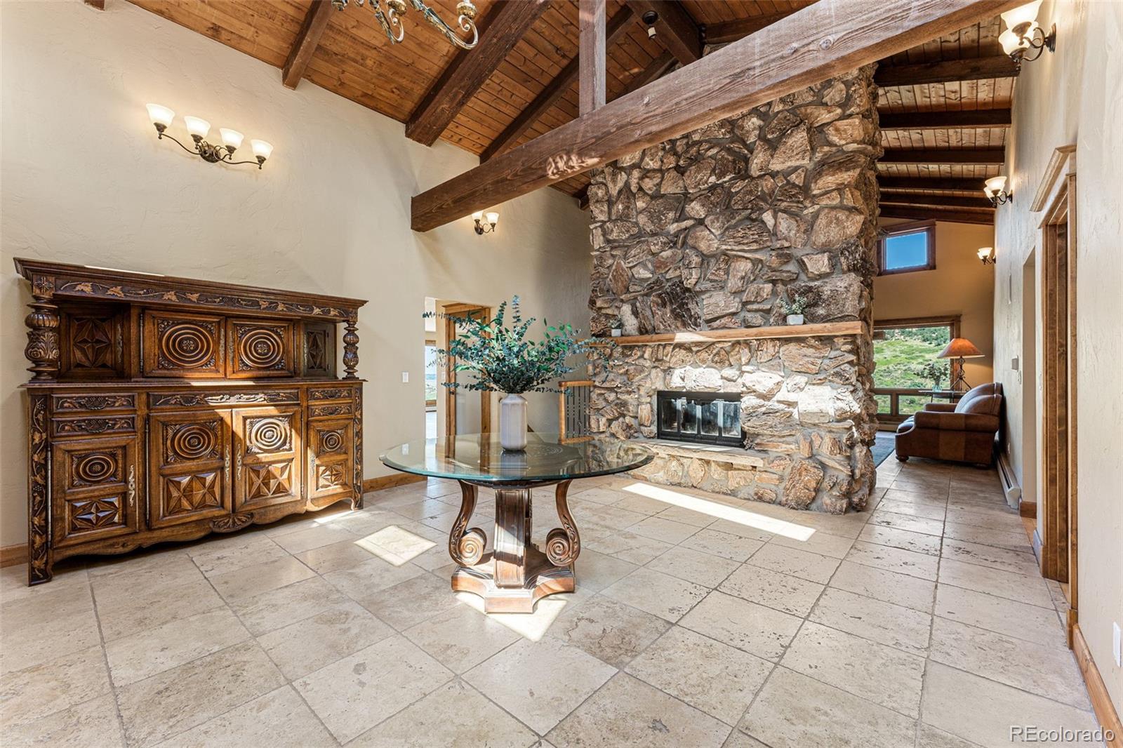 5970 Crestbrook Drive Morrison, CO 80465 - Photo 8 of 34 a view of a chairs and table in a patio
