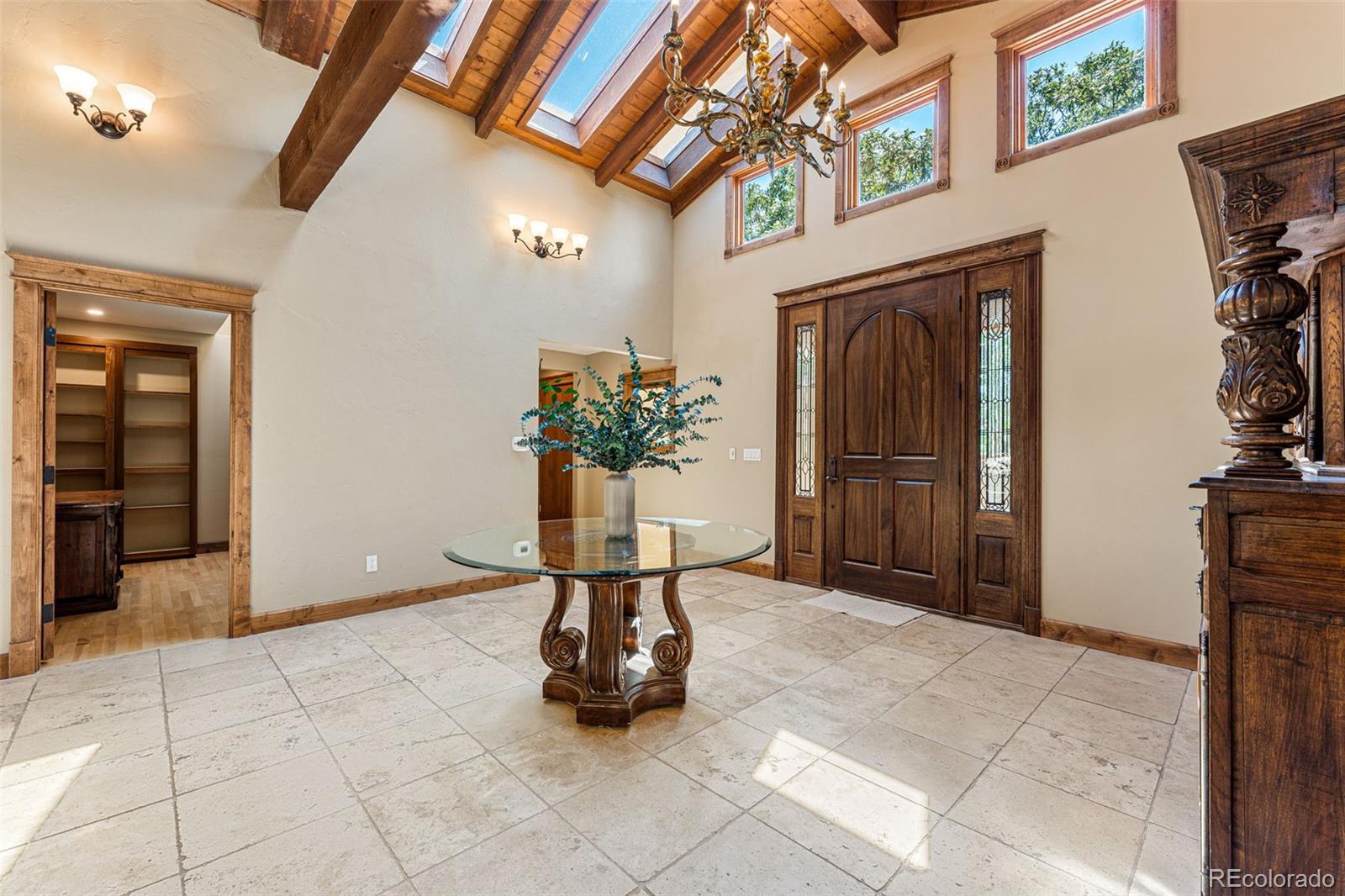 5970 Crestbrook Drive Morrison, CO 80465 - Photo 9 of 34 a view of an entryway with a flower pot and a bookshelf