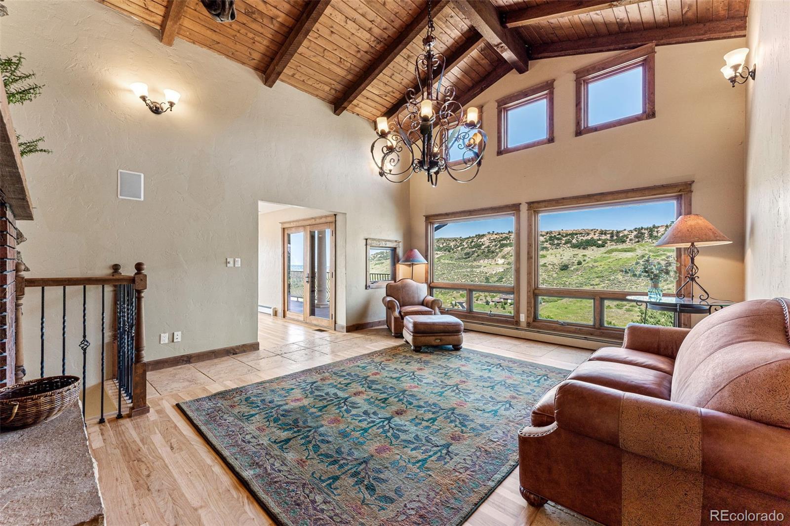 5970 Crestbrook Drive Morrison, CO 80465 - Photo 10 of 34 a living room with furniture floor to ceiling window and wooden floor