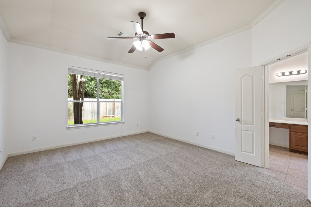 2617 Salorn Way Round Rock, TX 78681 - Photo 17 of 40 an empty room with chandelier fan and windows