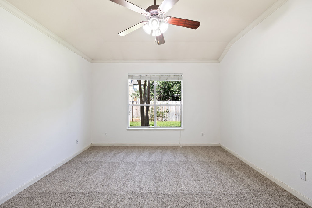 2617 Salorn Way Round Rock, TX 78681 - Photo 19 of 40 an empty room with a window and a ceiling fan