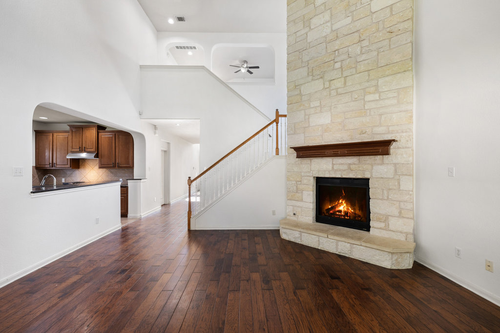 2617 Salorn Way Round Rock, TX 78681 - Photo 21 of 40 a living room with wooden floor and a fireplace