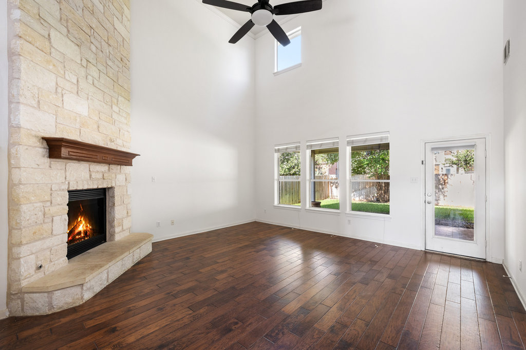 2617 Salorn Way Round Rock, TX 78681 - Photo 23 of 40 a view of an empty room with wooden floor fireplace and a window