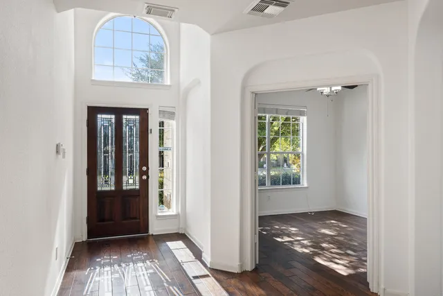 a view of an entryway with wooden floor