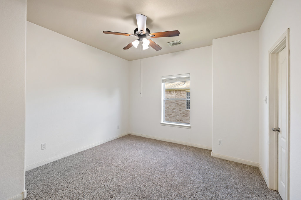 2617 Salorn Way Round Rock, TX 78681 - Photo 32 of 40 an empty room with windows and fan