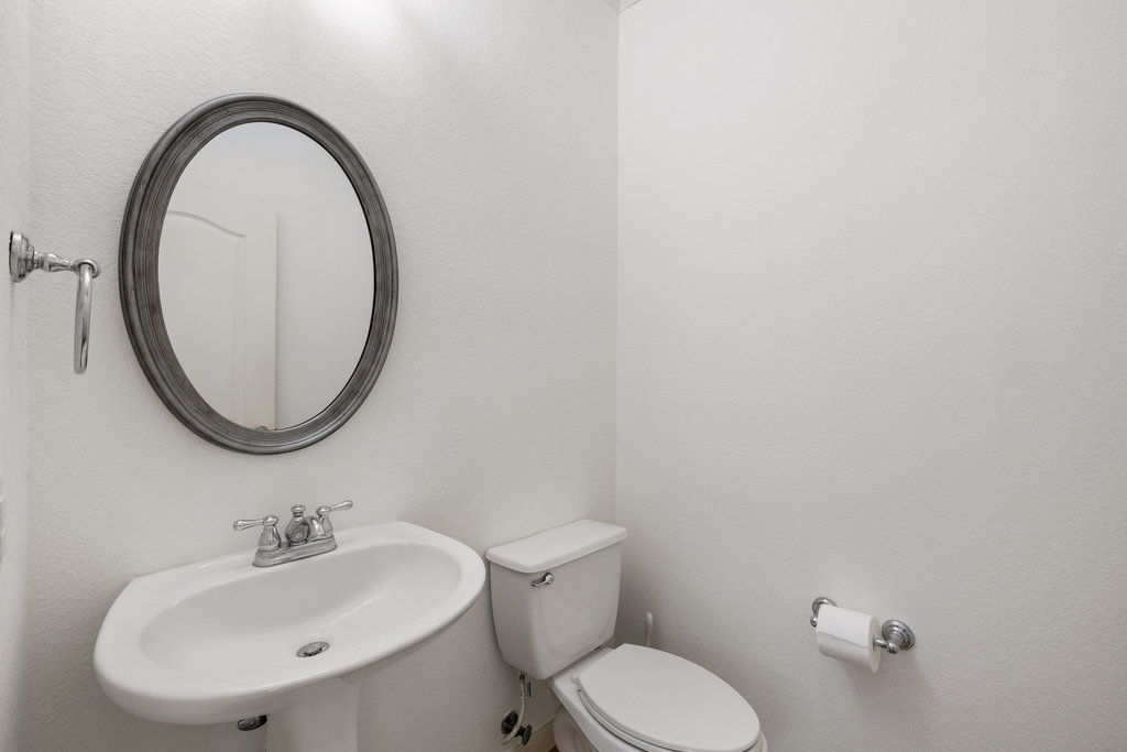 2617 Salorn Way Round Rock, TX 78681 - Photo 35 of 40 a bathroom with a toilet a sink and a mirror