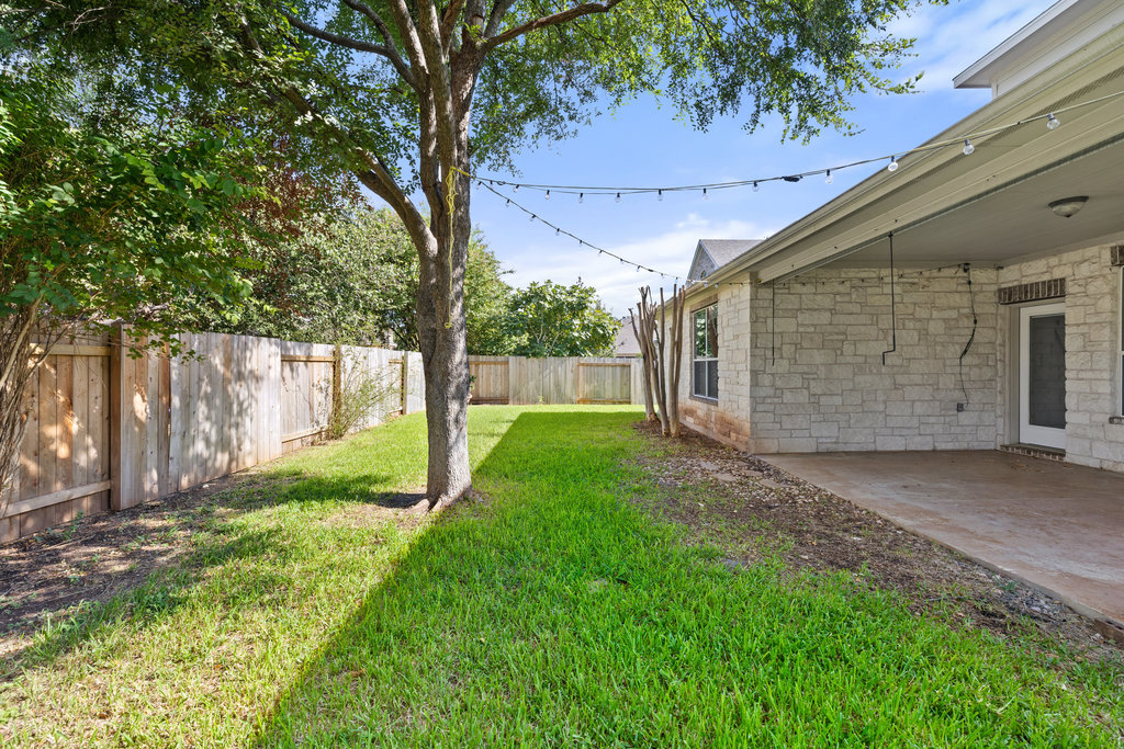 2617 Salorn Way Round Rock, TX 78681 - Photo 38 of 40 a view of a backyard with large trees and a barn