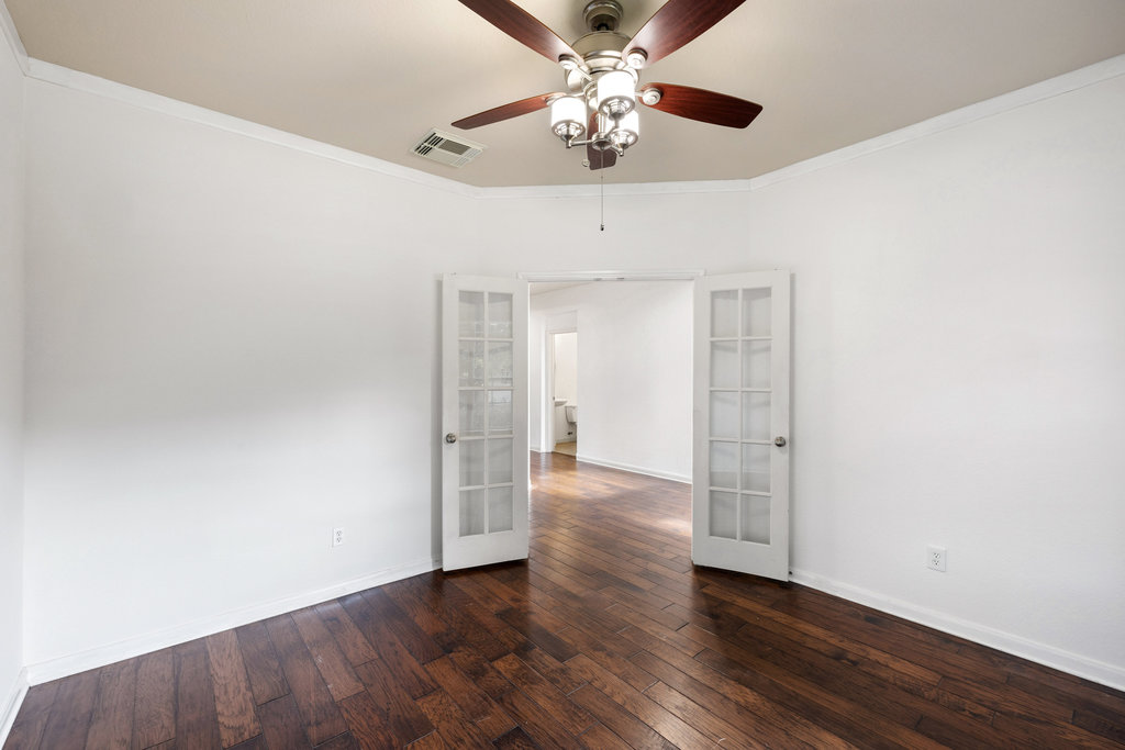 2617 Salorn Way Round Rock, TX 78681 - Photo 4 of 40 an empty room with wooden floor chandelier fan and closet area
