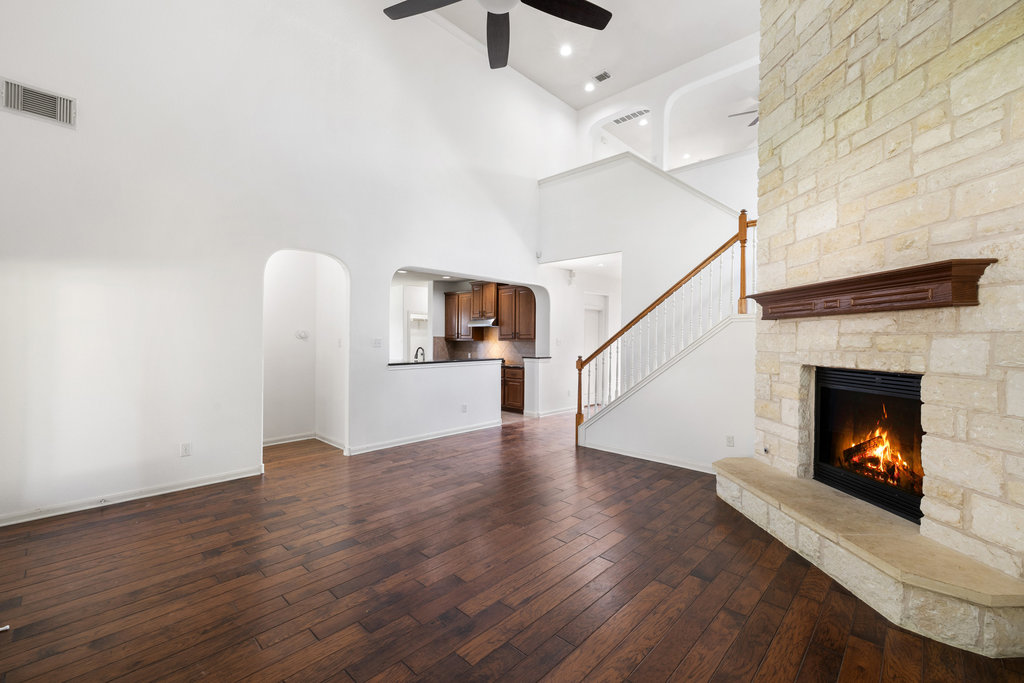 2617 Salorn Way Round Rock, TX 78681 - Photo 6 of 40 a view of a livingroom with wooden floor a fireplace and window