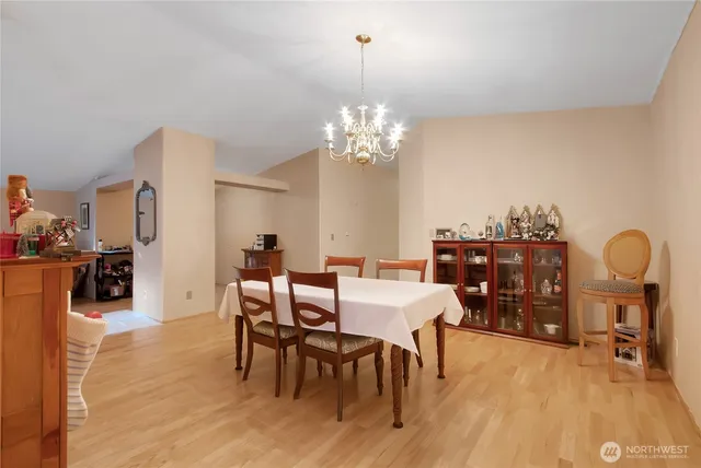 a view of a dining room with furniture and chandelier