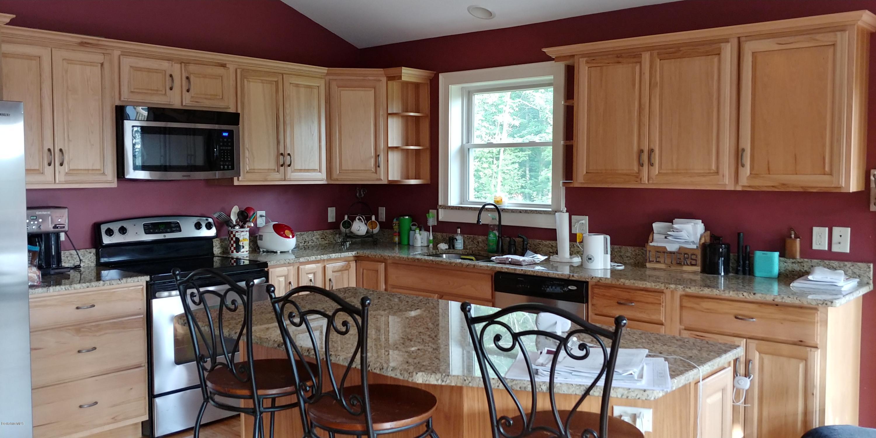 229 East Windsor Road Peru, MA 01235 - Photo 3 of 9 a kitchen with stainless steel appliances granite countertop a stove a sink dishwasher and a microwave with wooden cabinets